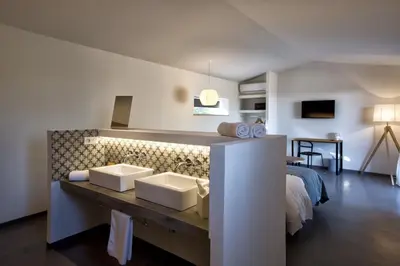 a room with a bed and two sinks in it at Hotel Les Chambres de Mila Bonifacio in Bonifacio
