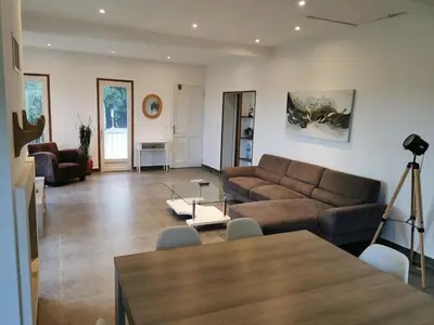 a living room with a couch and a table at Maison avec vue sur la mer et piscine in Talasani