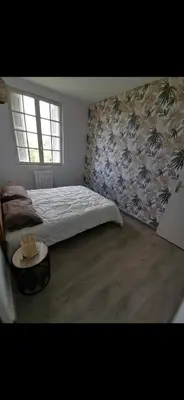 a bedroom with a bed and a table in it at Maison avec vue sur la mer et piscine in Talasani