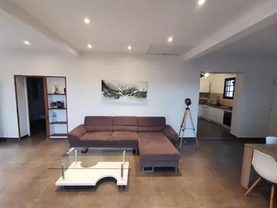 a living room with a couch and a coffee table at Maison avec vue sur la mer et piscine in Talasani
