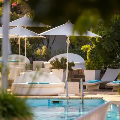 a swimming pool with chairs and umbrellas and a tub at A'mare Corsica I Seaside Small Resort in Propriano