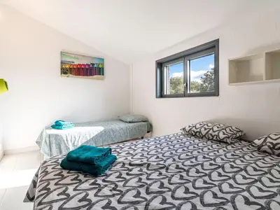 a bedroom with two beds and a window at Villa Villa Romana by Interhome in Porto-Vecchio