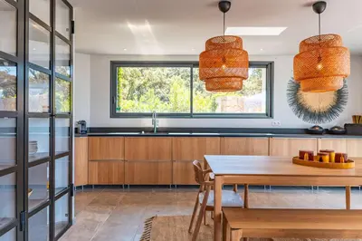 a kitchen with a wooden table and a sink at Villa Cala Rossa Di Lecci in Lecci