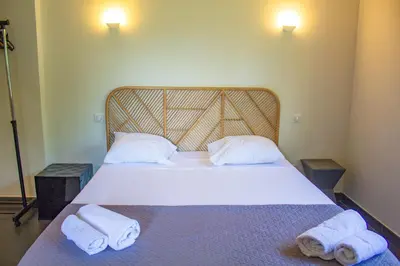 a bedroom with a bed with two towels on it at Villa Trinidad Di Porto-Vecchio in Porto-Vecchio