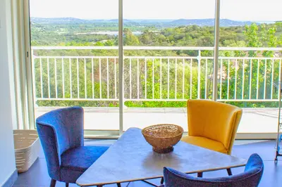 a room with a table and chairs and a large window at Villa Trinidad Di Porto-Vecchio in Porto-Vecchio