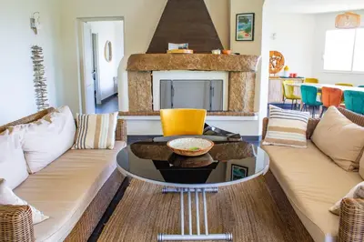 a living room with two couches and a fireplace at Villa Trinidad Di Porto-Vecchio in Porto-Vecchio