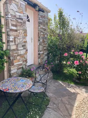 a table and chairs sitting in front of a house at Chez Liselotte in Borgo