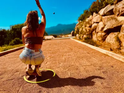 a woman riding a skateboard down a road at Domaine Aria di Terra***** in Figari