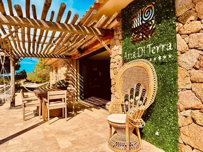 a group of chairs sitting outside of a building at Domaine Aria di Terra***** in Figari