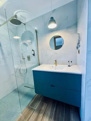 a bathroom with a blue sink and a shower at Domaine Aria di Terra***** in Figari