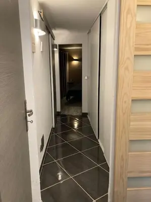 a hallway with a tile floor and a door at Maison SAINTE LUCIE DE PORTO-VECCHIO in Sainte-Lucie de Porto-Vecchio