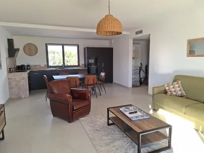 a living room with a couch and a table at Domaine d'Arca - Flaubert 22 - 3 pièces - étage 2 - Porto-Vecchio in Porto-Vecchio