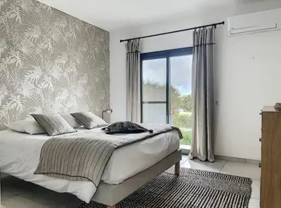 a bedroom with a bed and a large window at MONTE LEONE in Bonifacio