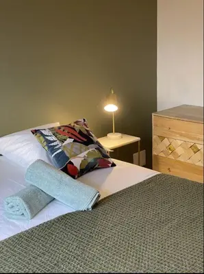 a bedroom with a bed with a pillow and a dresser at MONTE LEONE in Bonifacio
