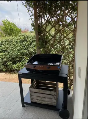 a grill on a table with a suitcase on it at MONTE LEONE in Bonifacio