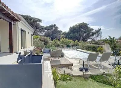 a patio with chairs and a swimming pool at MONTE LEONE in Bonifacio
