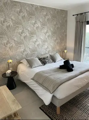 a bedroom with a large bed with a wall at MONTE LEONE in Bonifacio