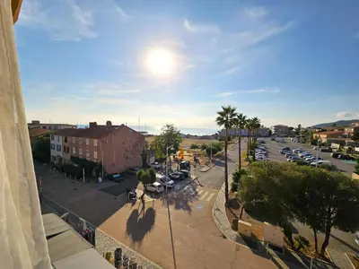 a view of a street with cars parked in a parking lot at Palmeraie 130- vue mer et village- plage et commerces à pieds in Sari Solenzara