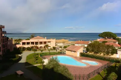 an overhead view of a swimming pool in front of a house at Palmeraie 130- vue mer et village- plage et commerces à pieds in Sari Solenzara