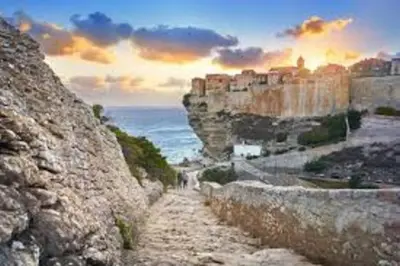 a view of a mountain with a city and the ocean at Superbe T2 neuf Bonifacio avec parking gratuit in Bonifacio