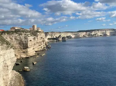 a large body of water with a castle on the cliff at Superbe T2 neuf Bonifacio avec parking gratuit in Bonifacio
