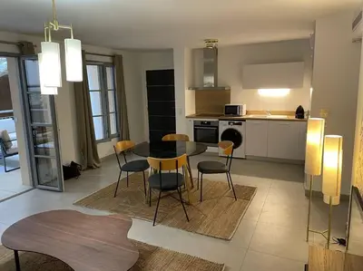 a kitchen and dining room with a table and chairs at Superbe T2 neuf Bonifacio avec parking gratuit in Bonifacio