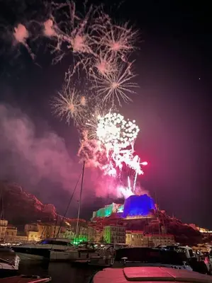 a firework display in the sky over a harbor with boats at Superbe T2 neuf Bonifacio avec parking gratuit in Bonifacio