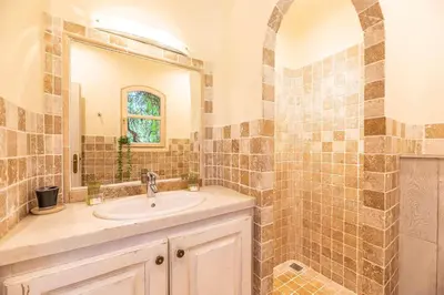 a bathroom with a sink and a mirror at Magnifique Villa de Luxe avec Piscine in Porto-Vecchio