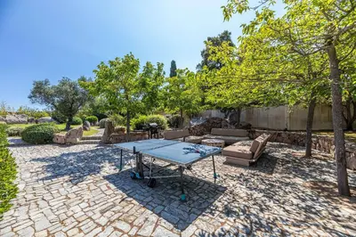 a patio with a table and a couch at Magnifique Villa de Luxe avec Piscine in Porto-Vecchio