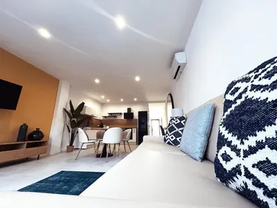 a bedroom with a bed and a dining room at Hôtel A Stretta in Propriano