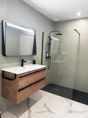 a bathroom with a sink and a shower with a mirror at Hôtel A Stretta in Propriano