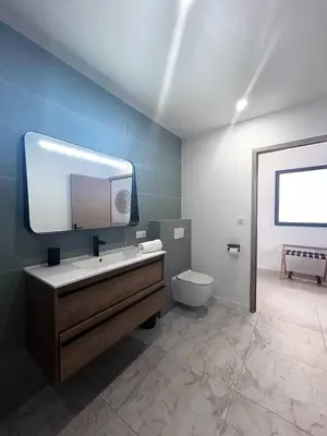 a bathroom with a sink and a toilet and a mirror at Hôtel A Stretta in Propriano
