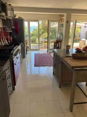 a kitchen with an island in the middle of a room at Rez de chaussée villa avec piscine in Piana
