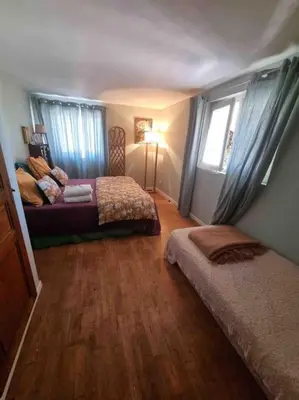 a bedroom with two beds and a window at Rez de chaussée villa avec piscine in Piana