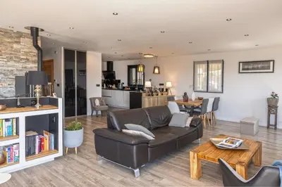 a living room with a couch and a table at Villa Les 2 F plage de Losari - Belgodère in Belgodère