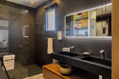 a bathroom with a black sink and a shower at Villa Les 2 F plage de Losari - Belgodère in Belgodère