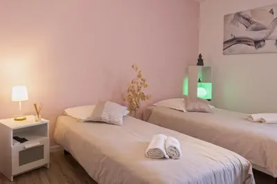 a room with two beds with towels on them at Villa Les 2 F plage de Losari - Belgodère in Belgodère