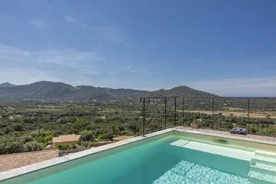 a swimming pool with a view of the mountains at Villa Les 2 F plage de Losari - Belgodère in Belgodère