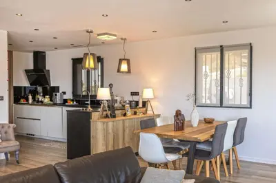 a kitchen and dining room with a table and chairs at Villa Les 2 F plage de Losari - Belgodère in Belgodère