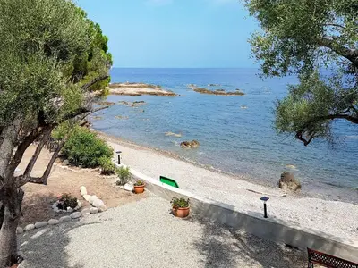 a beach with a teddy bear and plants and the water at Holiday Home Dentice by Interhome in Sari Solenzara
