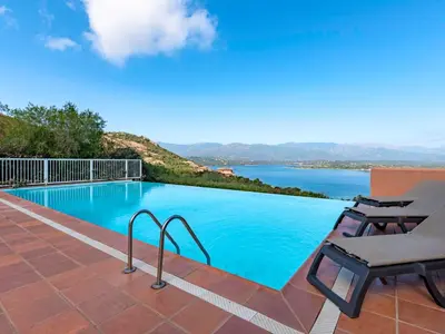 a swimming pool with a view of the water at Holiday Home Verde by Interhome in Porto-Vecchio