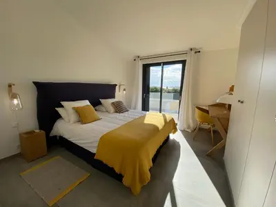 a bedroom with a bed with a yellow blanket on it at Villa Arazu, 10 personnes, piscine chauffée, vue mer, 15 minutes à pieds plage in Cirendinu