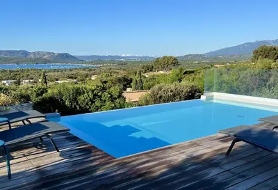 a swimming pool with a view of the mountains at Villa Arazu, 10 personnes, piscine chauffée, vue mer, 15 minutes à pieds plage in Cirendinu