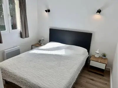 a bedroom with a large bed with a black headboard at Havre de paix Fiori di Cala Rossa in Lecci