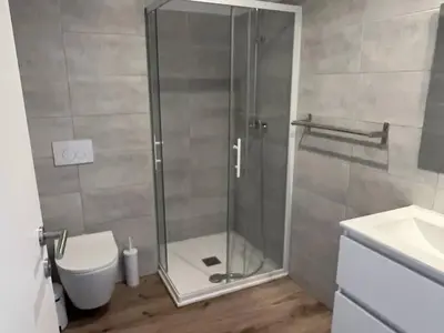 a shower with a glass door in a bathroom at Havre de paix Fiori di Cala Rossa in Lecci