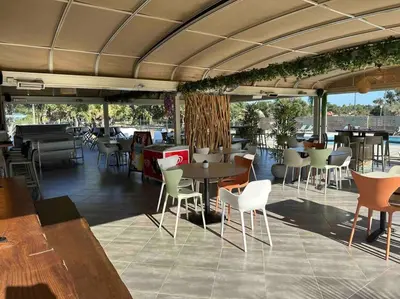 a restaurant with tables and chairs and tables and chairs at Mini villa T3 de 48m2 in Lecci