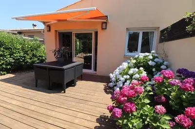 a wooden deck with a piano and flowers at Accommodation Close To Pinarello Beach in Conca
