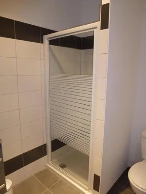 a shower with a glass door in a bathroom at Accommodation Close To Pinarello Beach in Conca