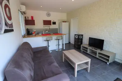 a living room with a couch and a kitchen at Accommodation Close To Pinarello Beach in Conca