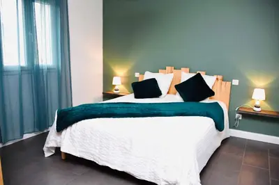 a bedroom with a large white bed with black pillows at Casa Serena in Linguizzetta